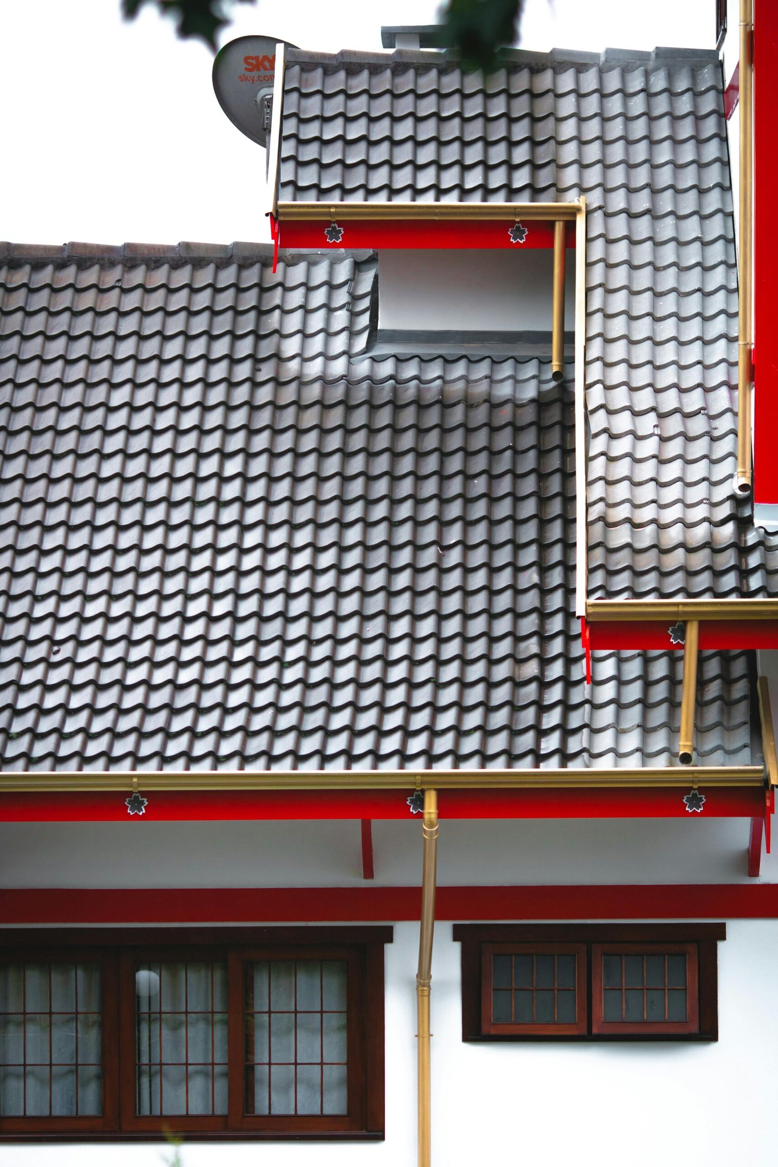 An architectural shot of a house exterior featuring a contemporary, tiled roof design.