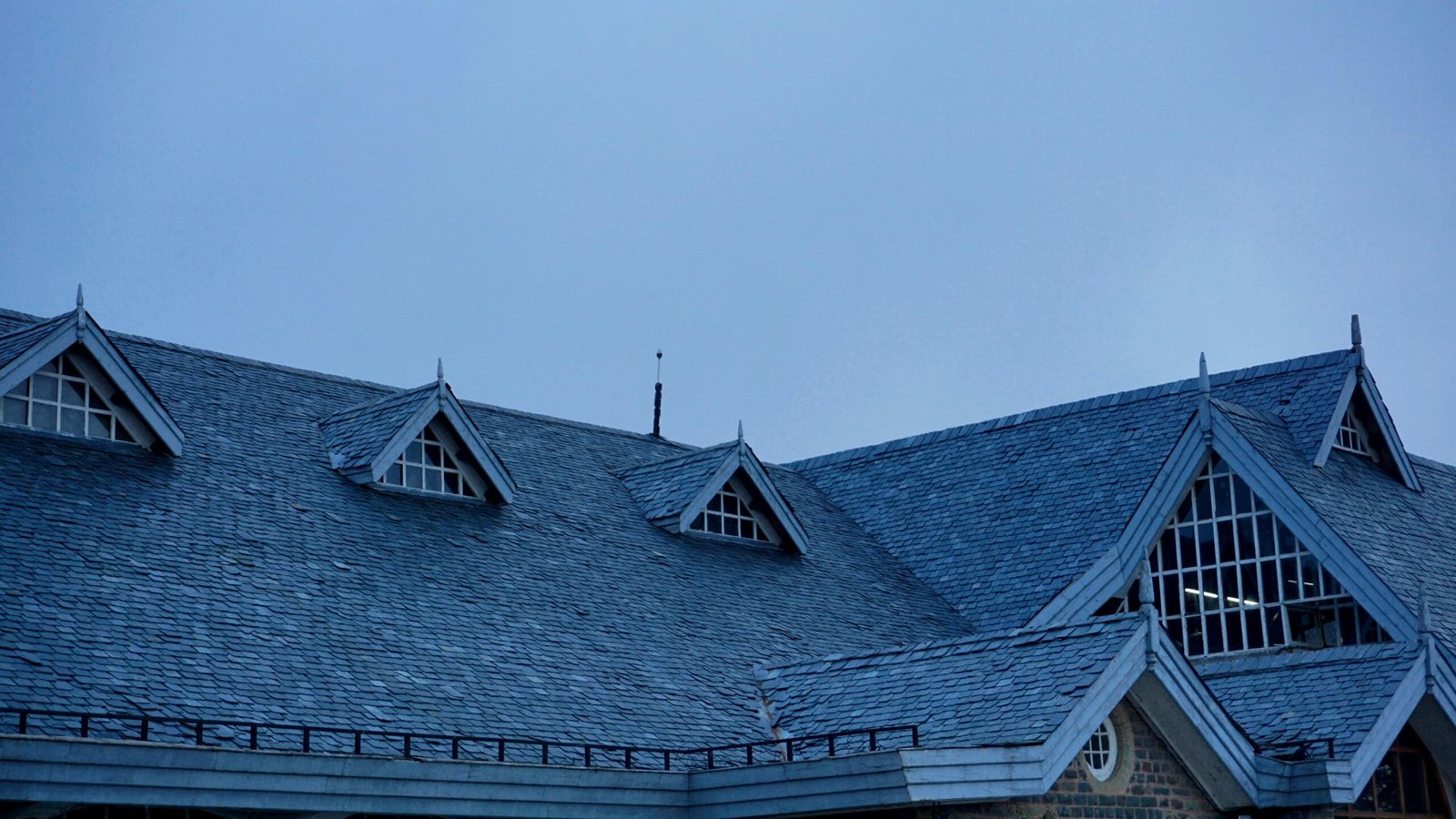 A contemporary rooftop with unique architectural elements set against a deep blue evening sky.