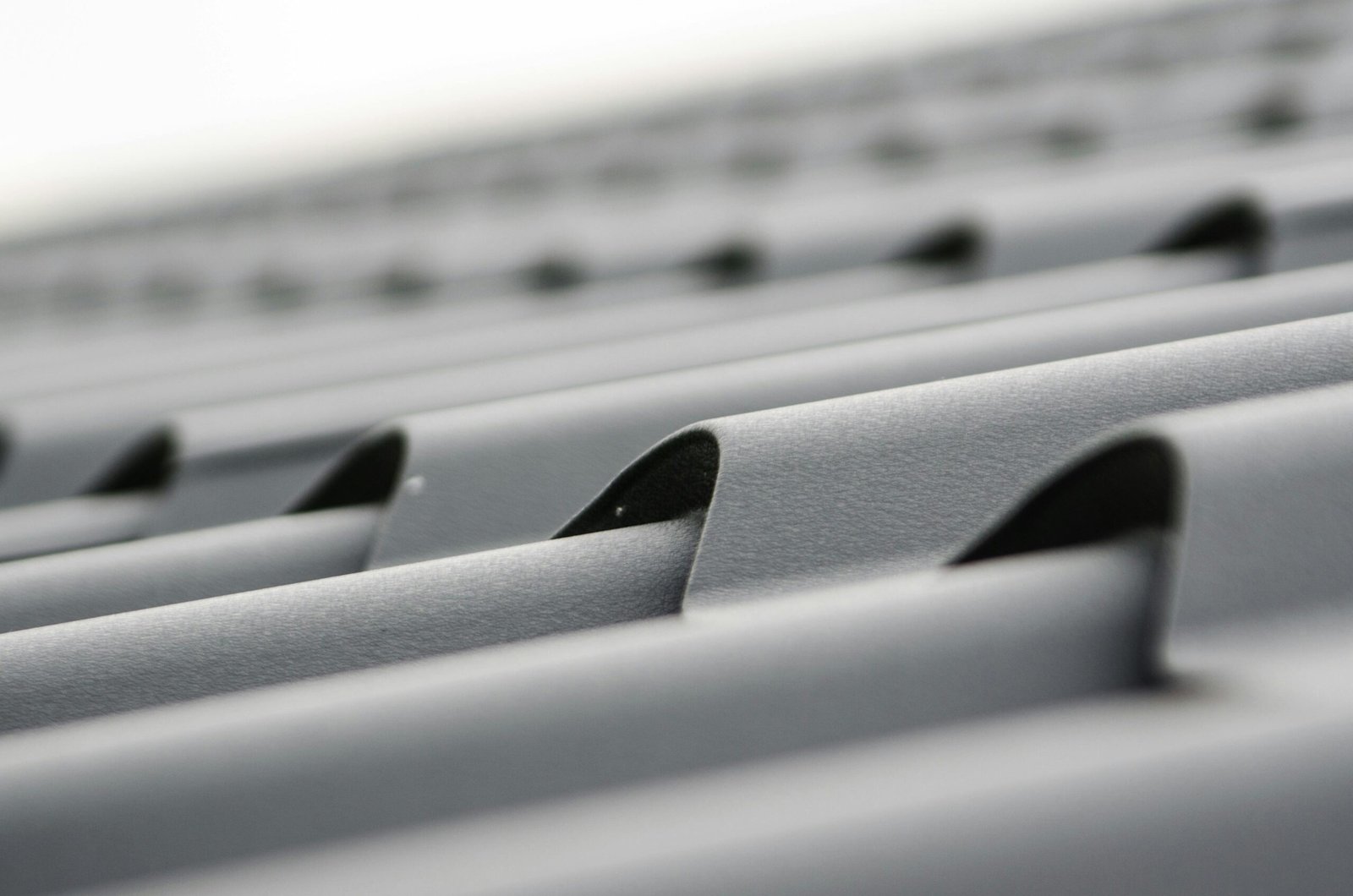 Detailed close-up of grey metal roof sheets showcasing texture and design.